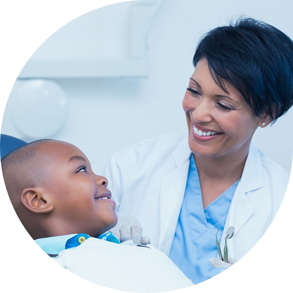 Dentist working with young patient